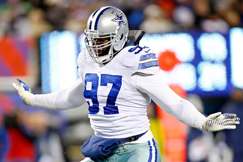 Dallas Cowboys defensive tackle Jason Hatcher reacts after sacking New York Giants...