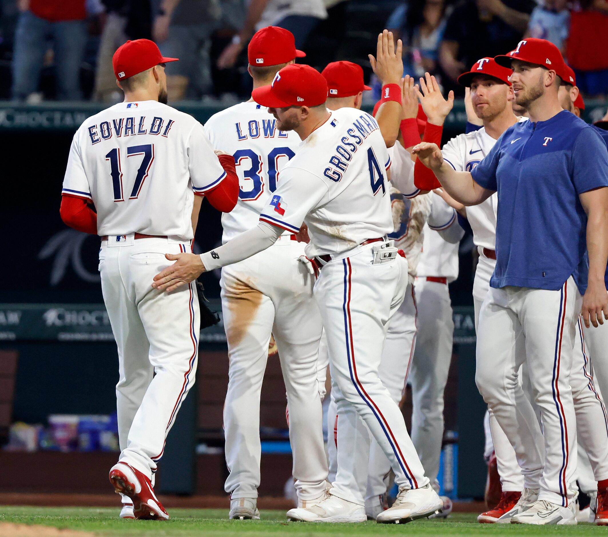 Texas Rangers starting pitcher Nathan Eovaldi (17) receives a slap on the fannie from...