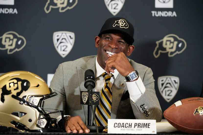 Deion Sanders speaks after being introduced as the new head football coach at the University...