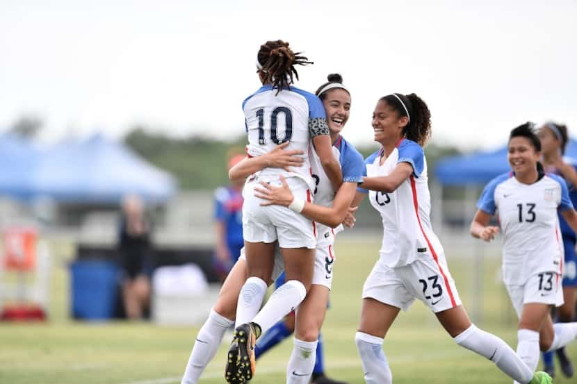 Diana Ordoñez (8) celebrates with Mia Fishel (10) after Fishel's opening goal of a 10-1 win...