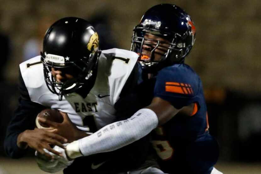 Plano East QB Brandon Mallory (1) is sacked by Sachse defender Anthony Anyanwu (46) during...