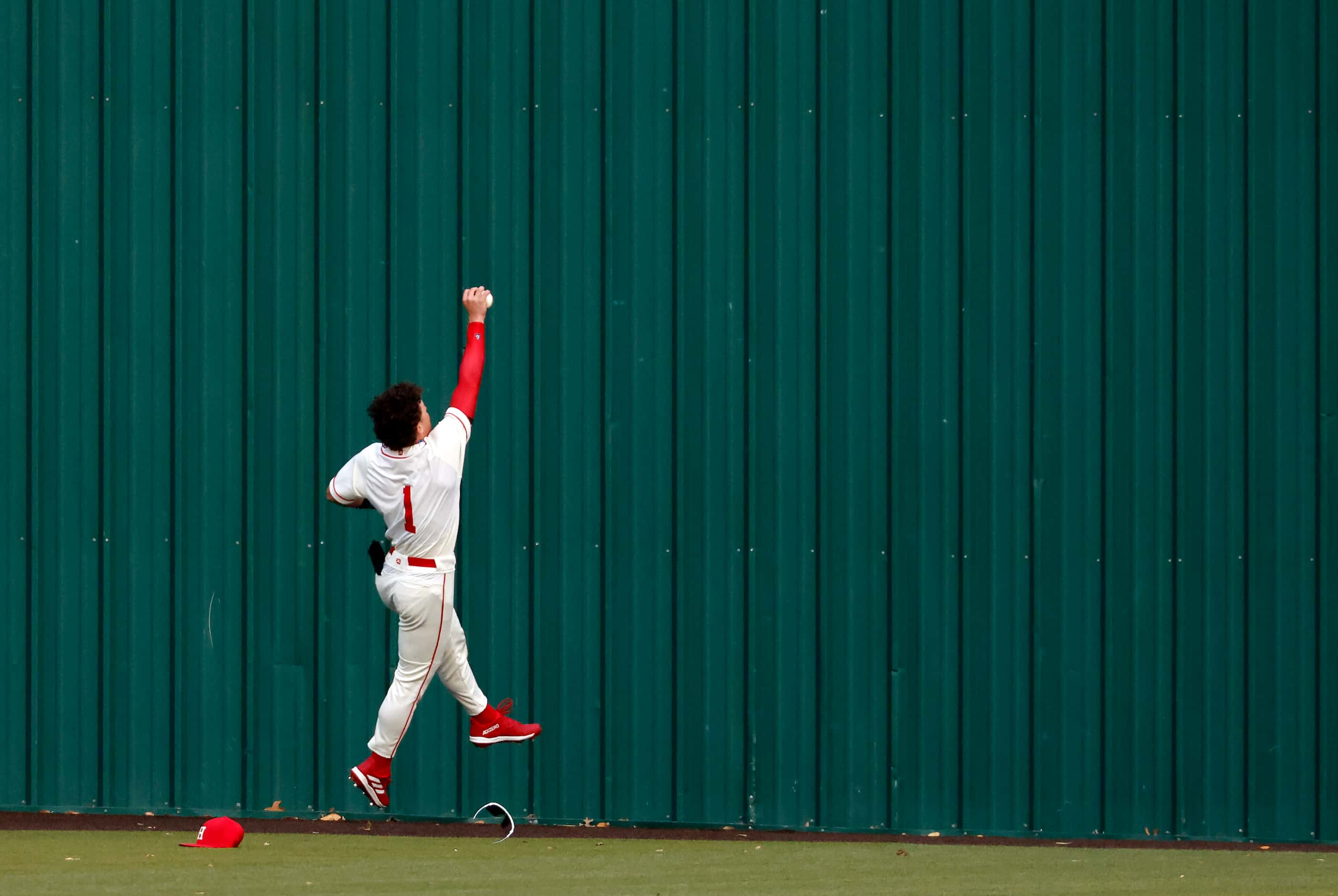 Rockwall-Heath High centerfielder makes a one-handed catch off the wall before throwing it...