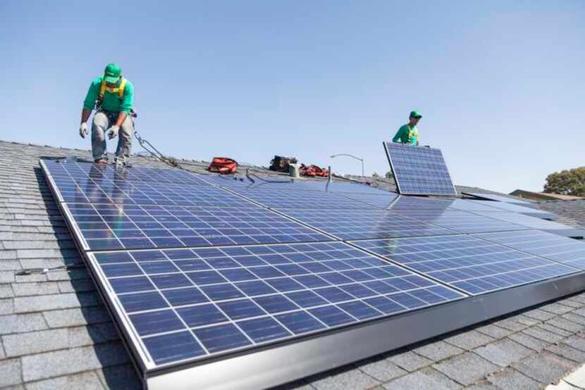 
SolarCity‘s panels on the east-facing roof of an Old East Dallas condo, are installed under...