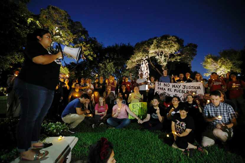 A statue of Robert E. Lee stands in the background as Democratic Socialists of America,...