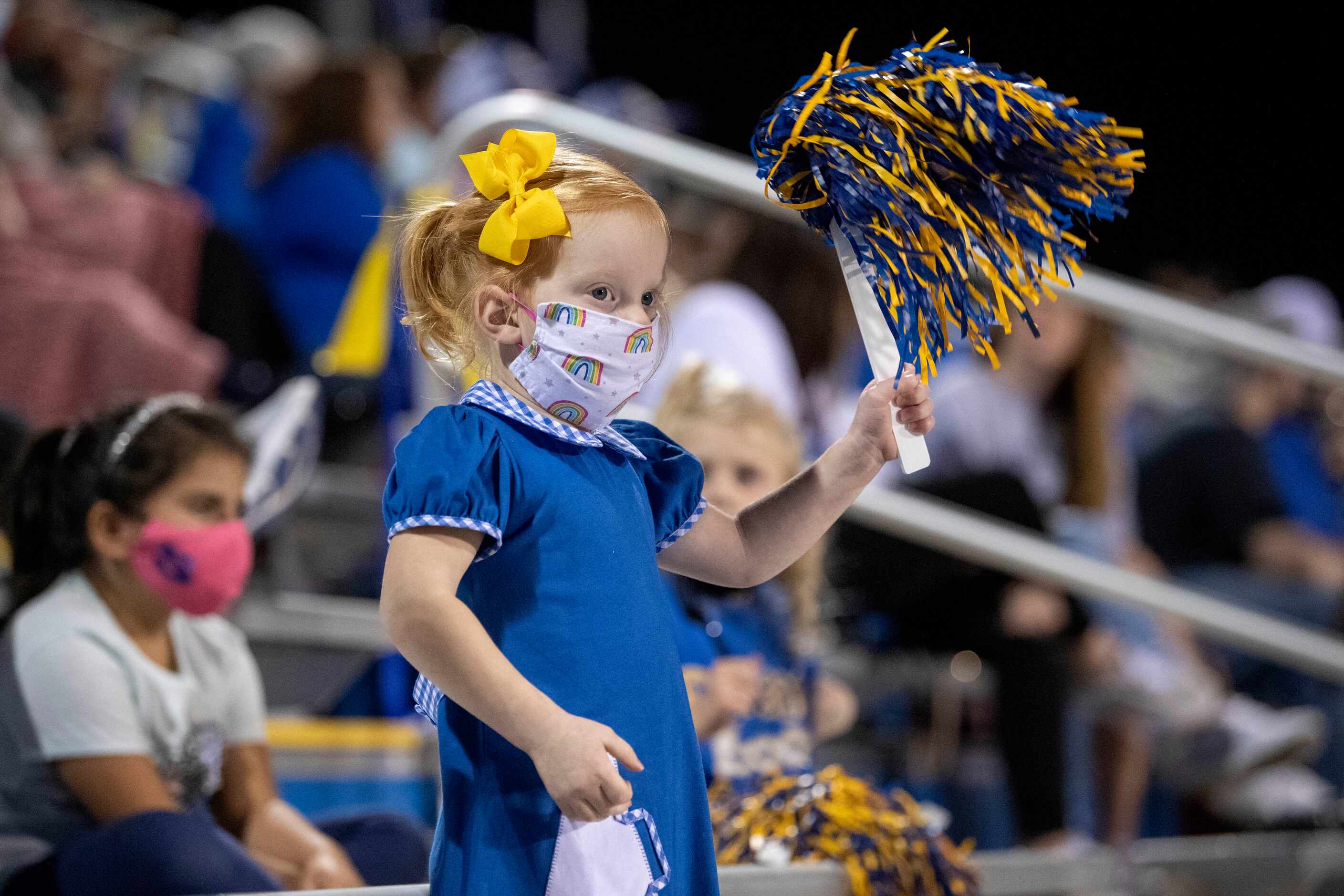 Ella Miracle, 3, whose babysitter is a Sunnyvale cheerleader, cheers on her team during the...