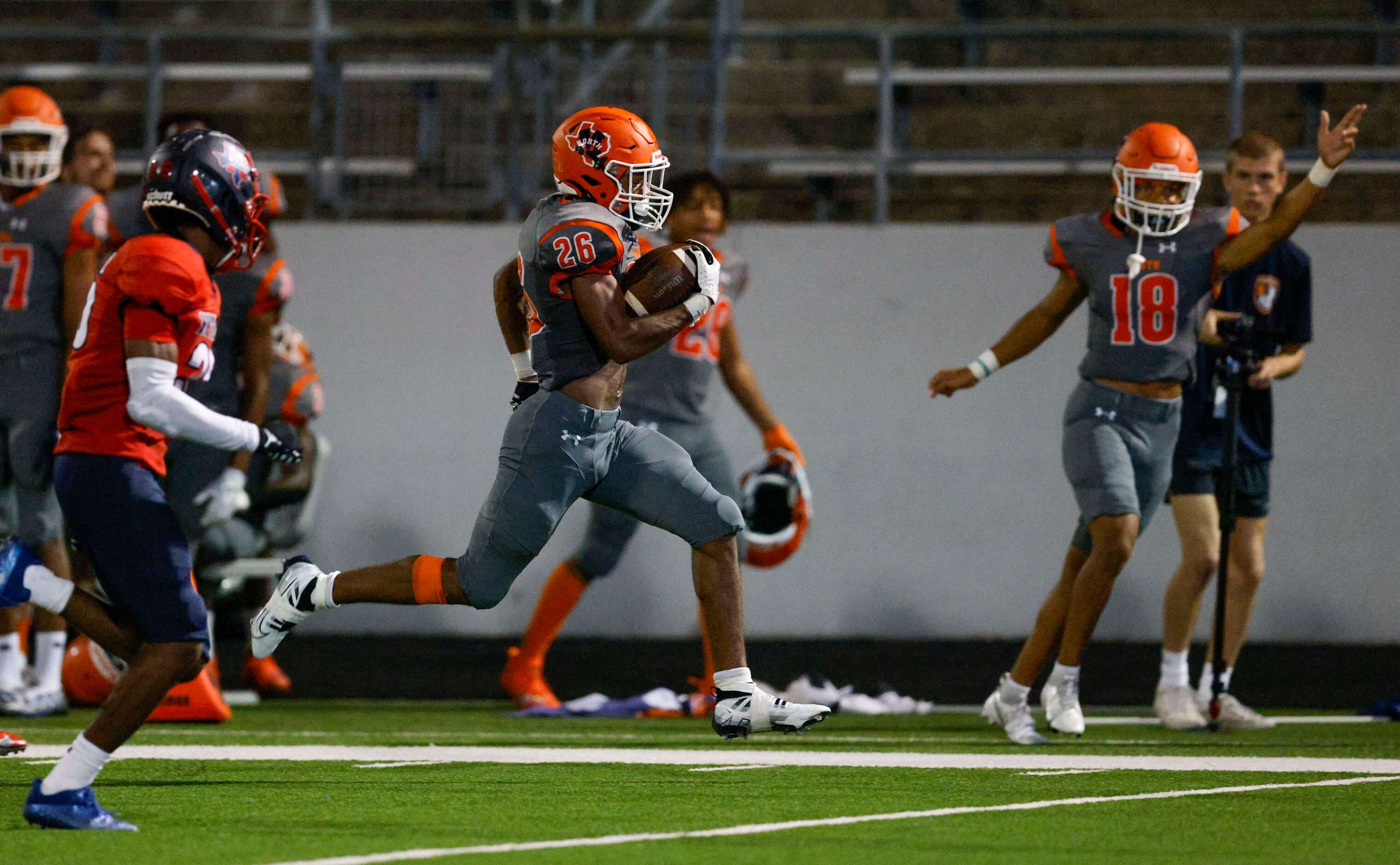 McKinney North running back Jayden Walker (26) runs along the sideline ahead of Justin...