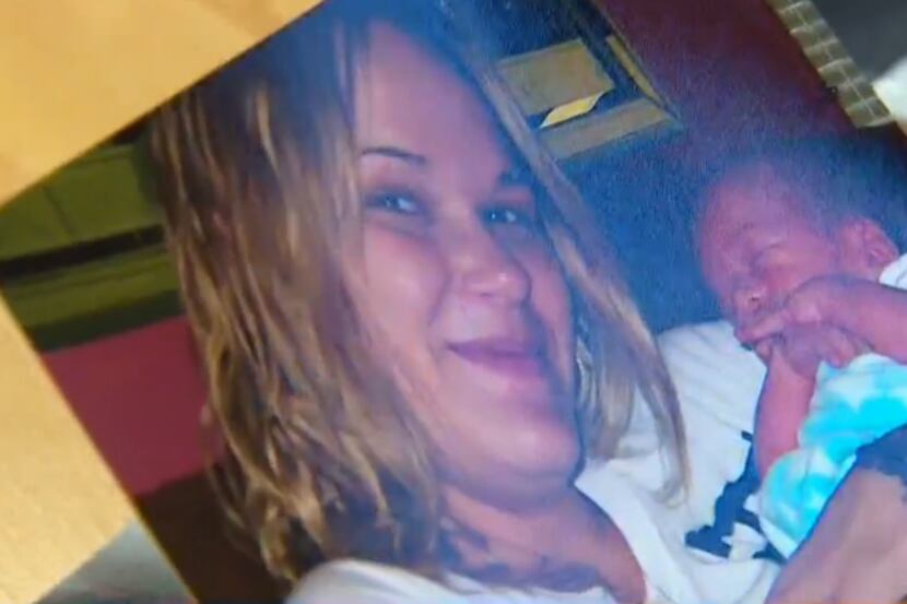 Angelica Ahern holds a photo of her with son Christian in a still shot from WFAA's report.