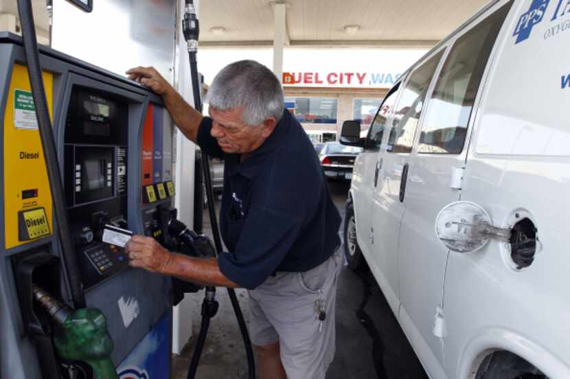 Steve Burrow inserted his credit card to purchase gas Wednesday at Fuel City in Dallas.