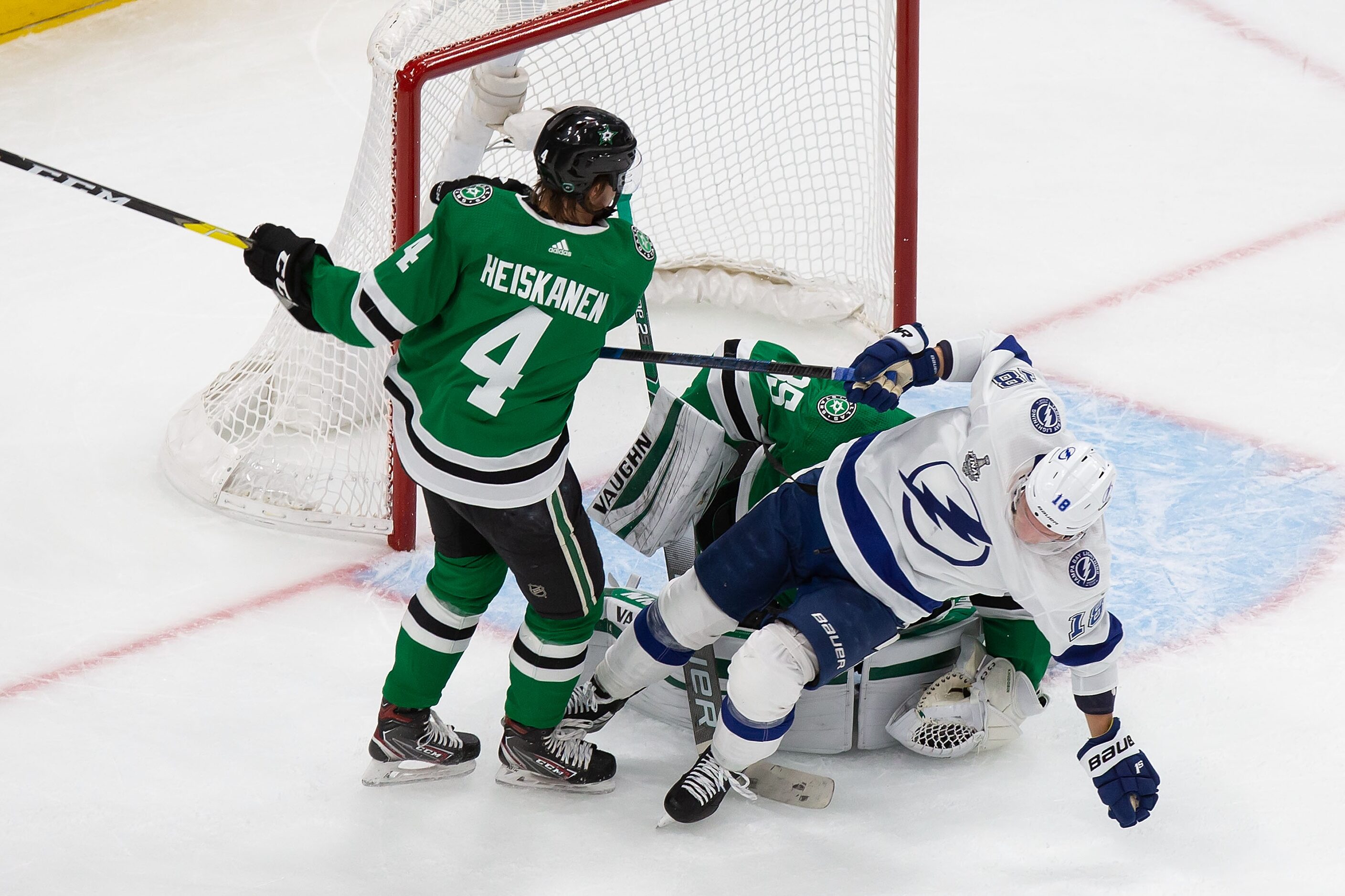 Miro Heiskanen (4) of the Dallas Stars battles against Ondrej Palat (18) of the Tampa Bay...