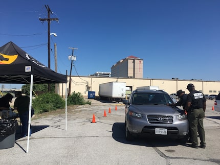 Cars wait in line to be etched in a Dallas County Health and Human Services parking lot...