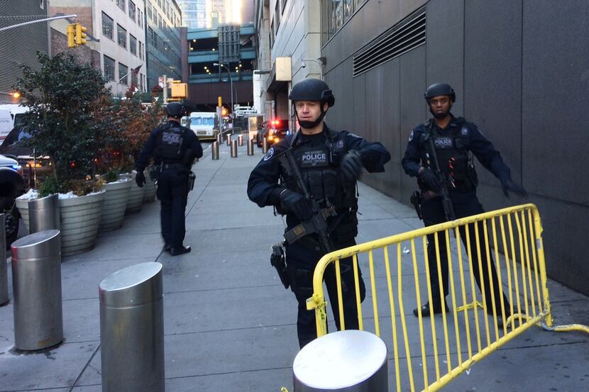Police block off a sidewalk while responding to a report of an explosion near Times Square...