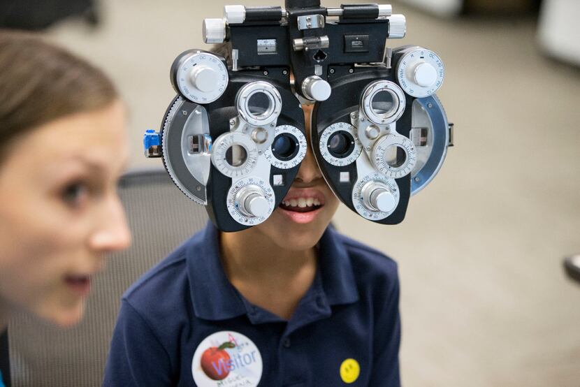 Miguel Bahena, 10, of Carrollton, Texas, gets a free eye exam provided by Essilor Vision...