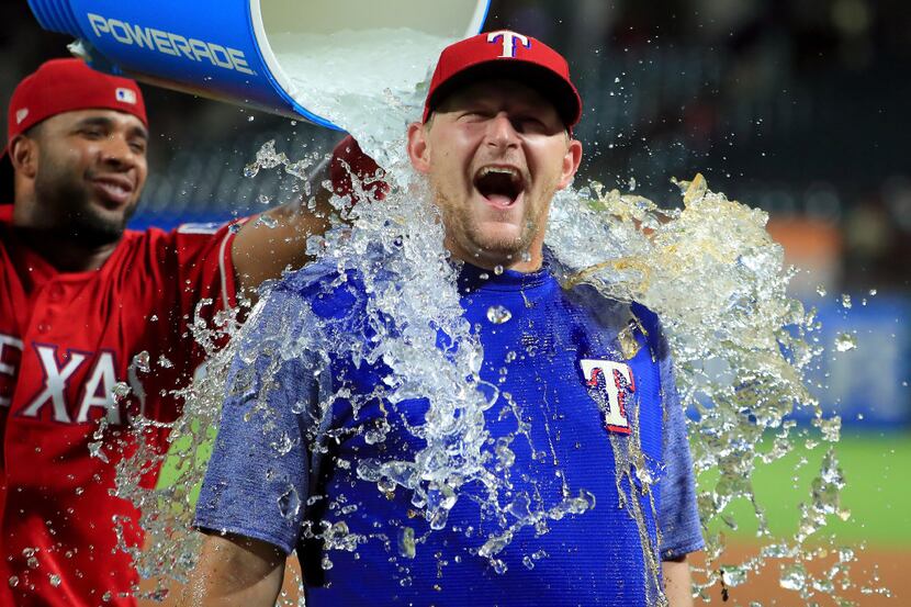 ARLINGTON, TX - AUGUST 17:  Elvis Andrus #1 of the Texas Rangers soaks Austin Bibens-Dirkx...