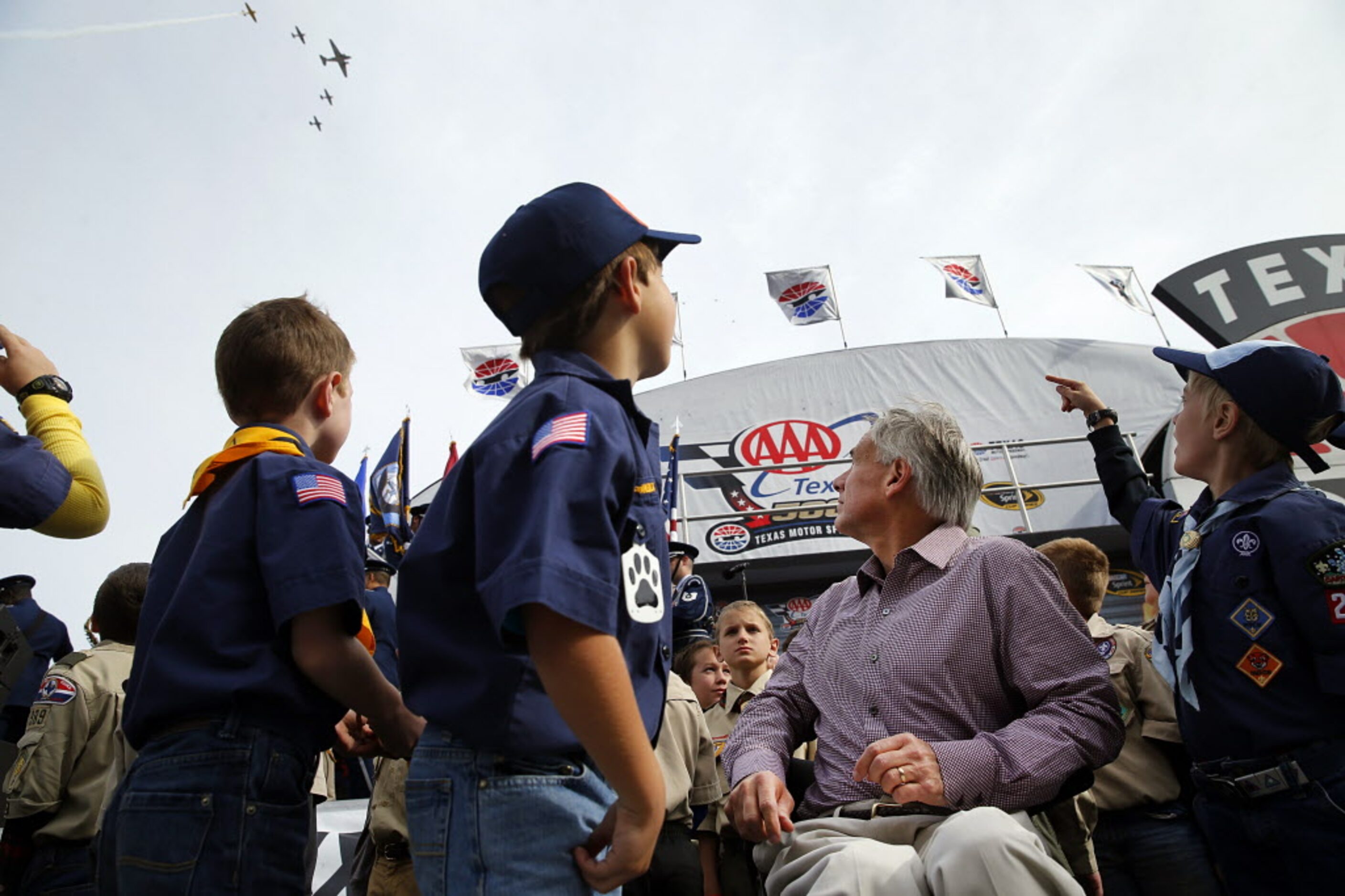 Republican Gubernatorial candidate and Texas Attorney General Greg Abbott (center) watches...