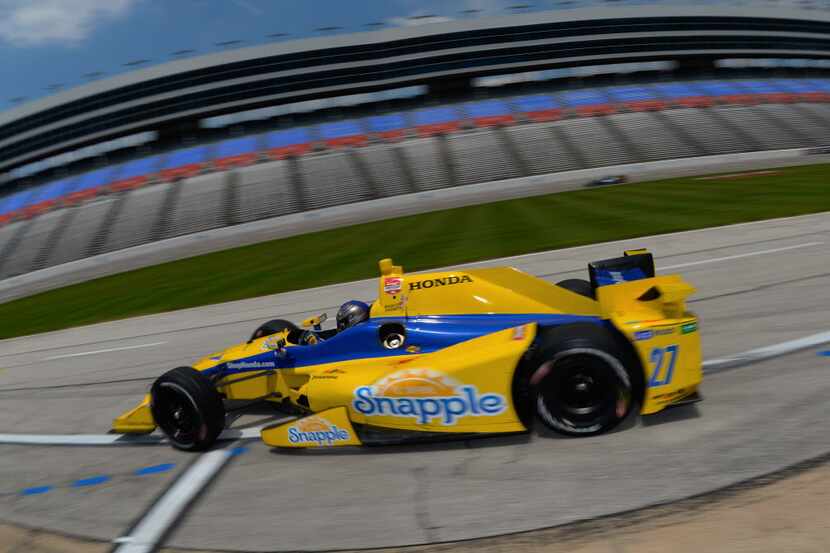  Marco Andretti, driver of the #27 Snapple Honda, drives off pit road during practice for...