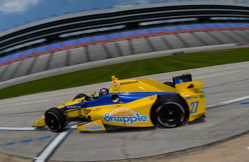  Marco Andretti, driver of the #27 Snapple Honda, drives off pit road during practice for...
