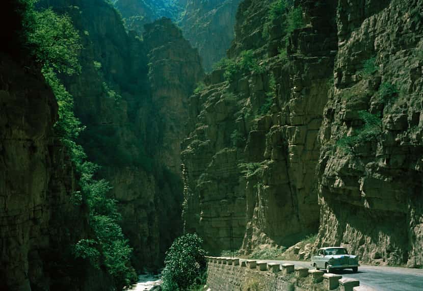A car travels on one of the major roads leading from Tehran across the Elburz Mountains to...