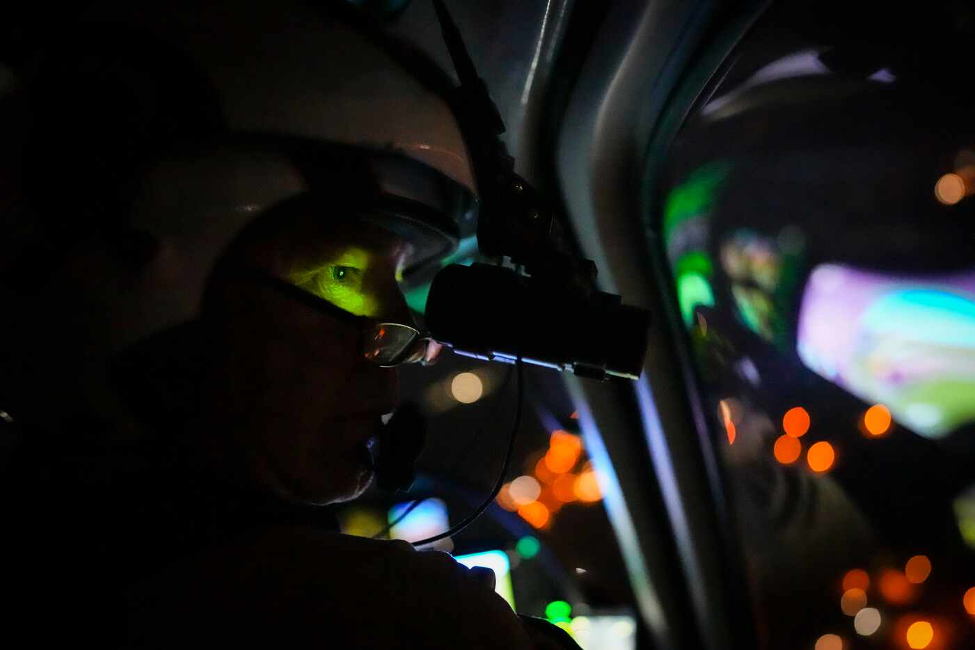 Texas Department of Public Safety pilot Lt. Donny Kindred uses night vision goggles as he...