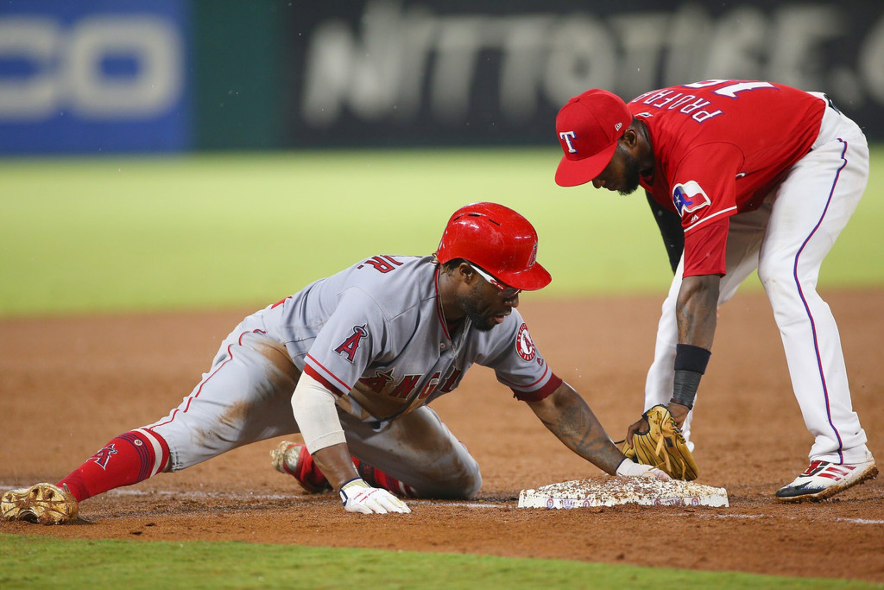 ARLINGTON, TX - AUGUST 18: Eric Young Jr. #9 of the Los Angeles Angels of Anaheim beats the...