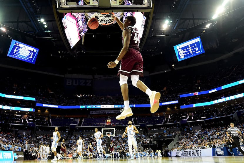 CHARLOTTE, NC - MARCH 18:  Robert Williams #44 of the Texas A&M Aggies dunks on the North...