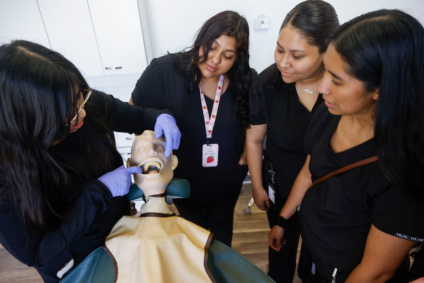 From left, Dental assistant teacher Jennifer Alvarado shows incoming students Alicia Diaz...