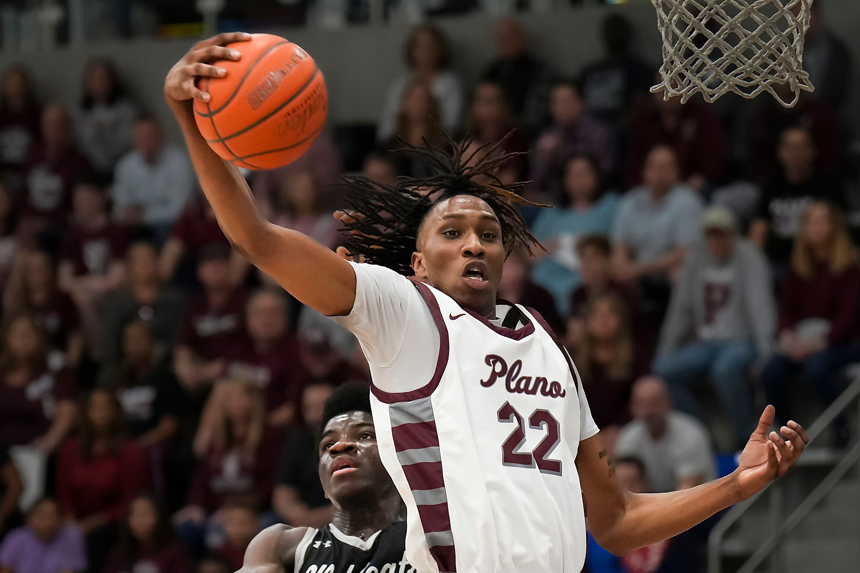 Plano forward Nikk Williams (22) grabs a rebound away from Denton Guyer forward Akintola...