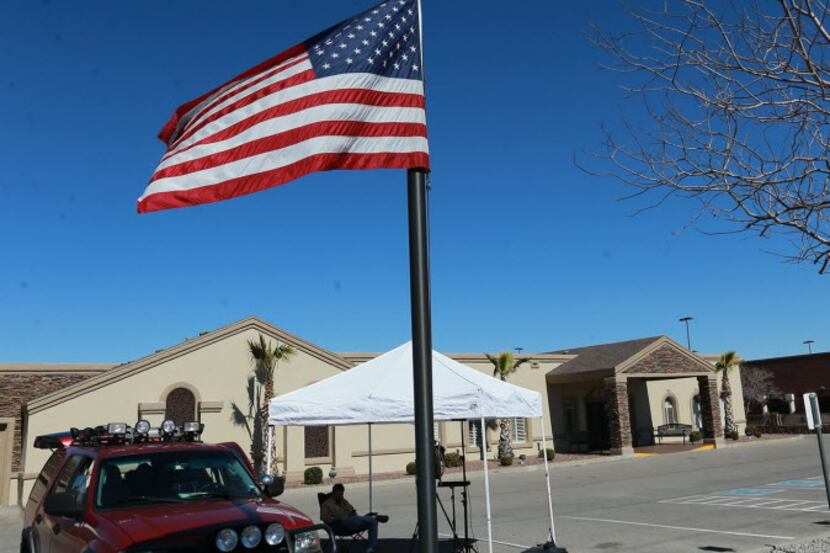  The U.S. flag flies at half-staff outside the Sunset Funeral Home, Sunday Feb. 14, 2016 in...