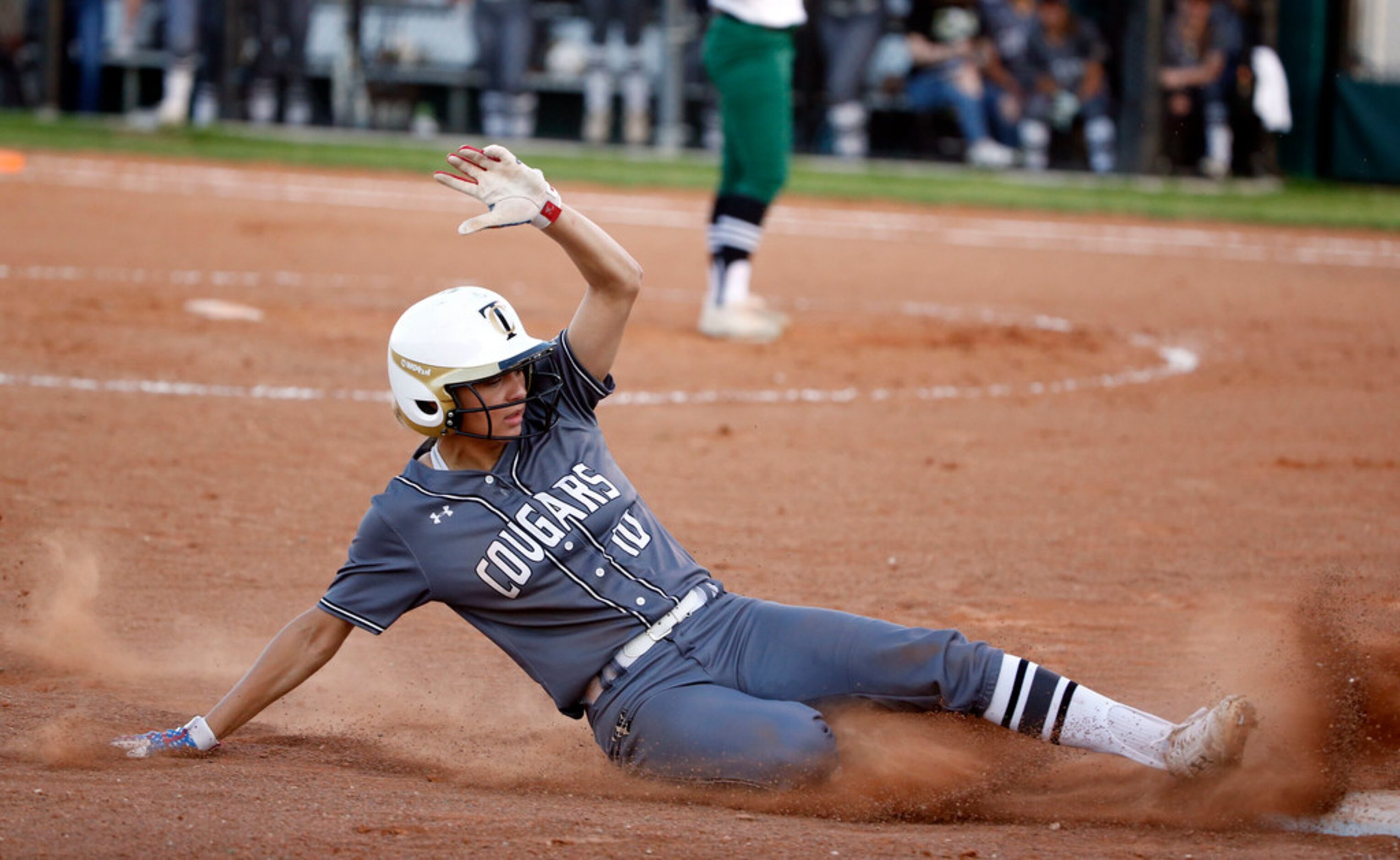 The Colony's Jayda Coleman (10) slides safely into third base against Birdville during game...