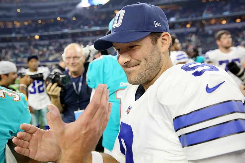 Dallas Cowboys quarterback Tony Romo (9) greets Miami Dolphins players and staff after a...