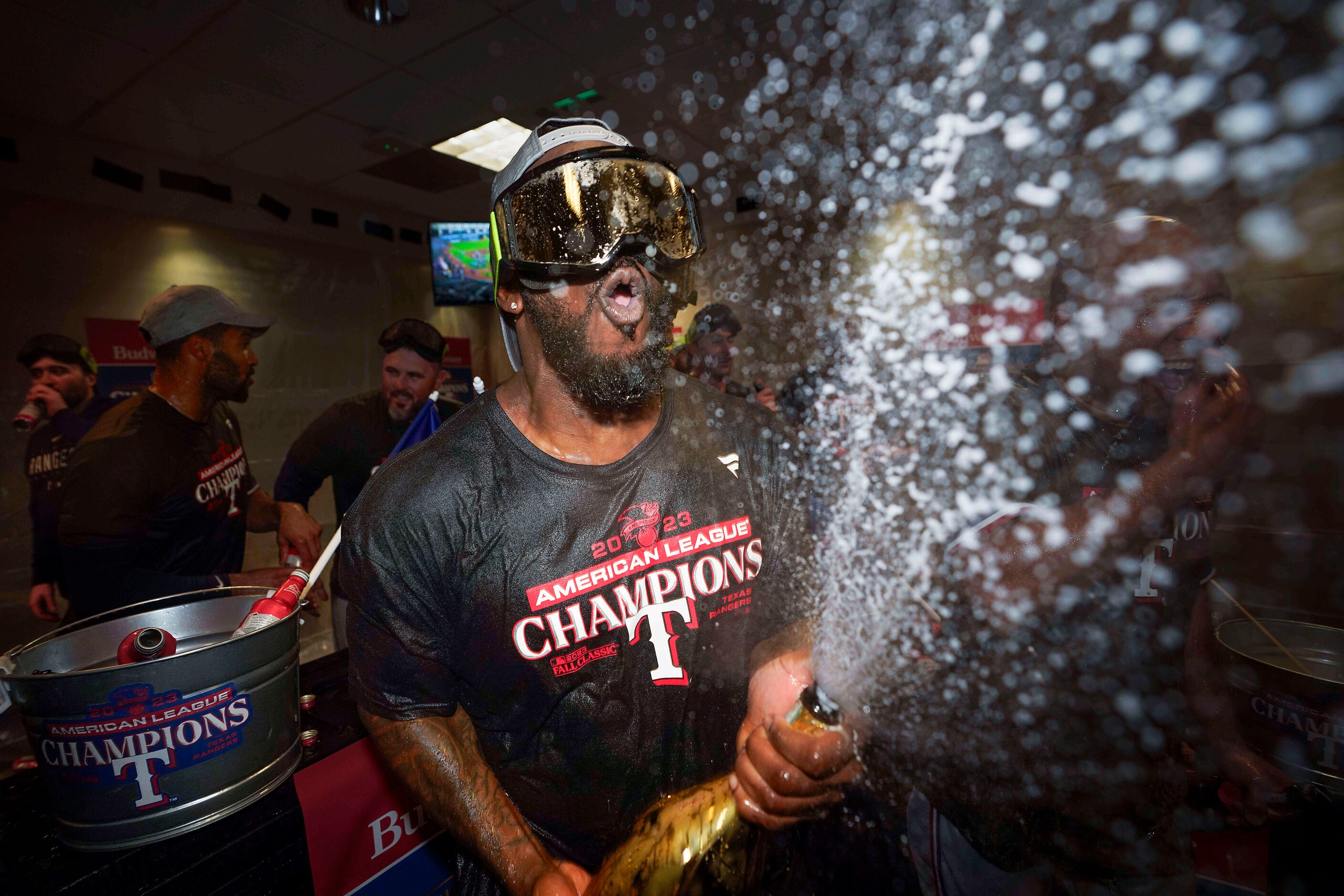 Texas Rangers right fielder Adolis Garcia celebrates in the clubhouse after the Rangers...