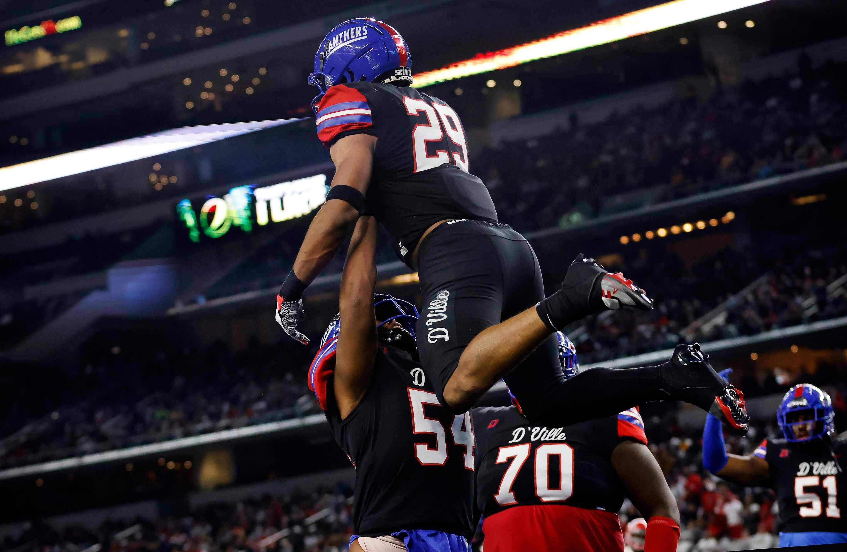 Duncanville running back Caden Durham (29) is hoisted in the air by teammate Jerry Scales...