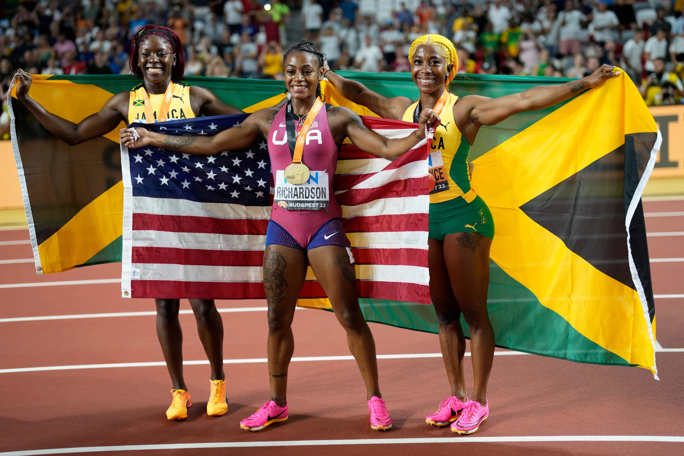 Silver medalist Shericka Jackson, of Jamaica, gold medalist Sha'Carri Richardson, of the...