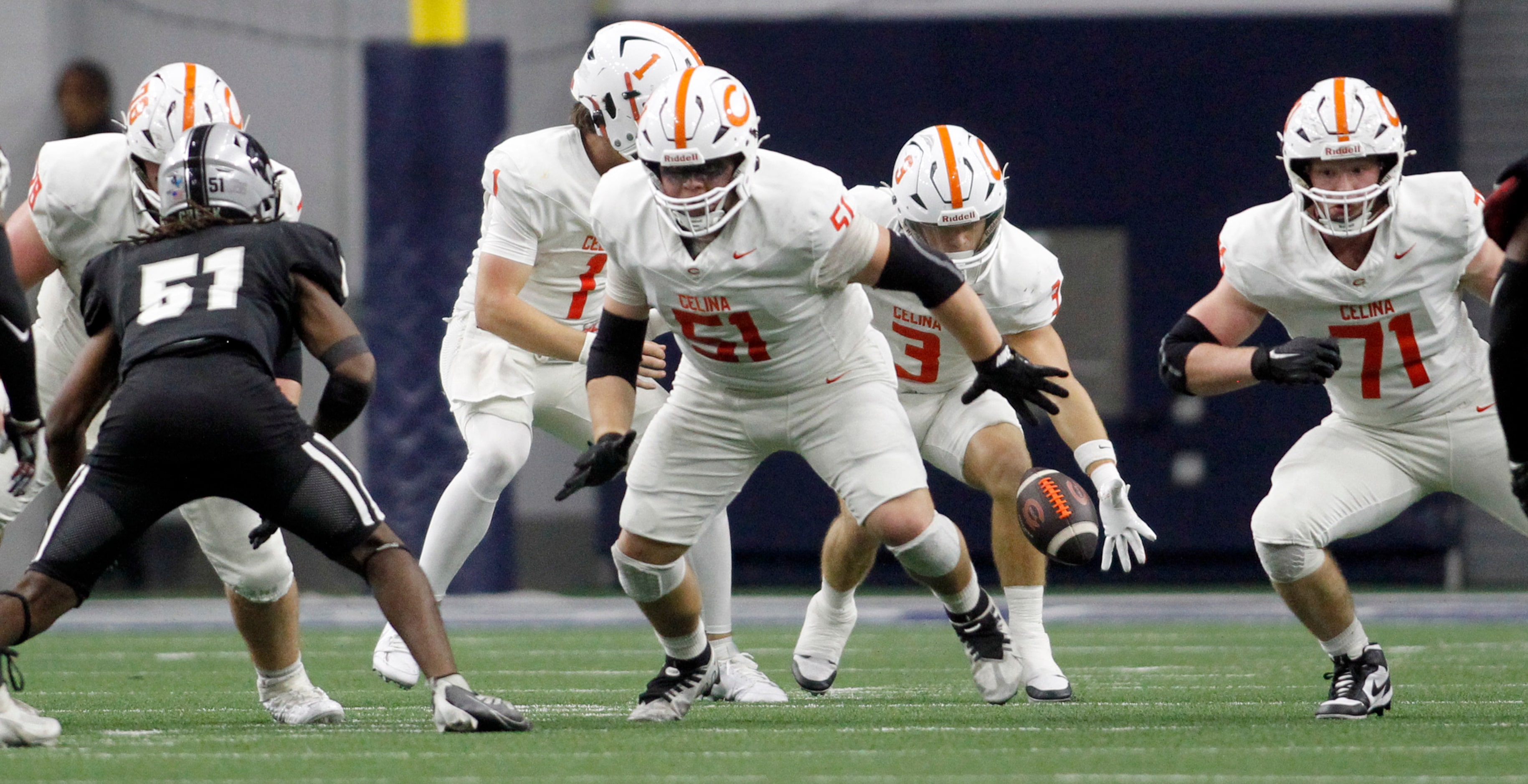 Celina running back Logan Gutierrez (3), center right, reaches for an unexpected snap from...