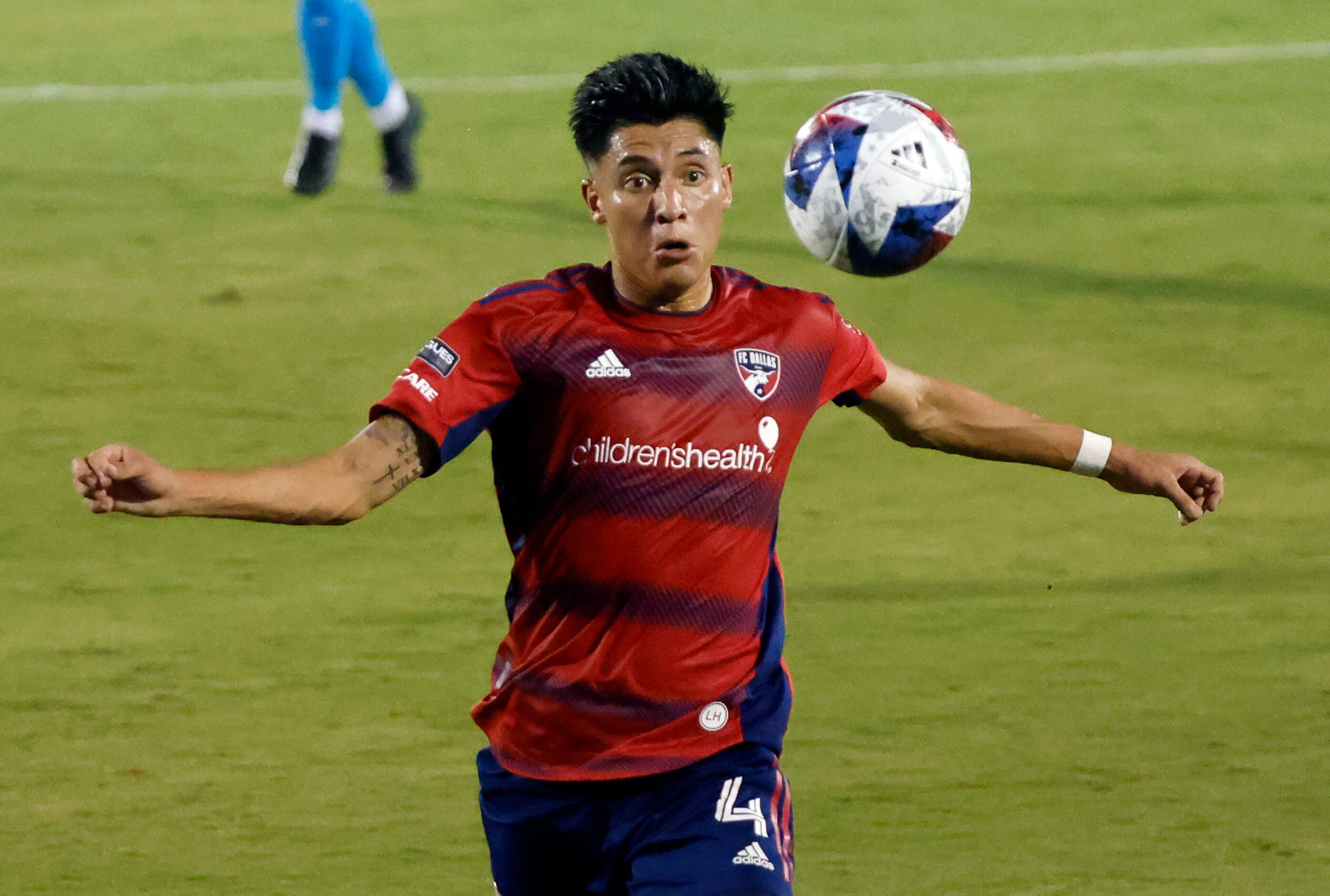 FC Dallas defender Marco Farfan (4) keeps up with a long kick against the Charlotte FC...