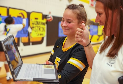 Fossil Ridge High School defensive specialist Ruslana Plaksii (5) speaks to her mother,...