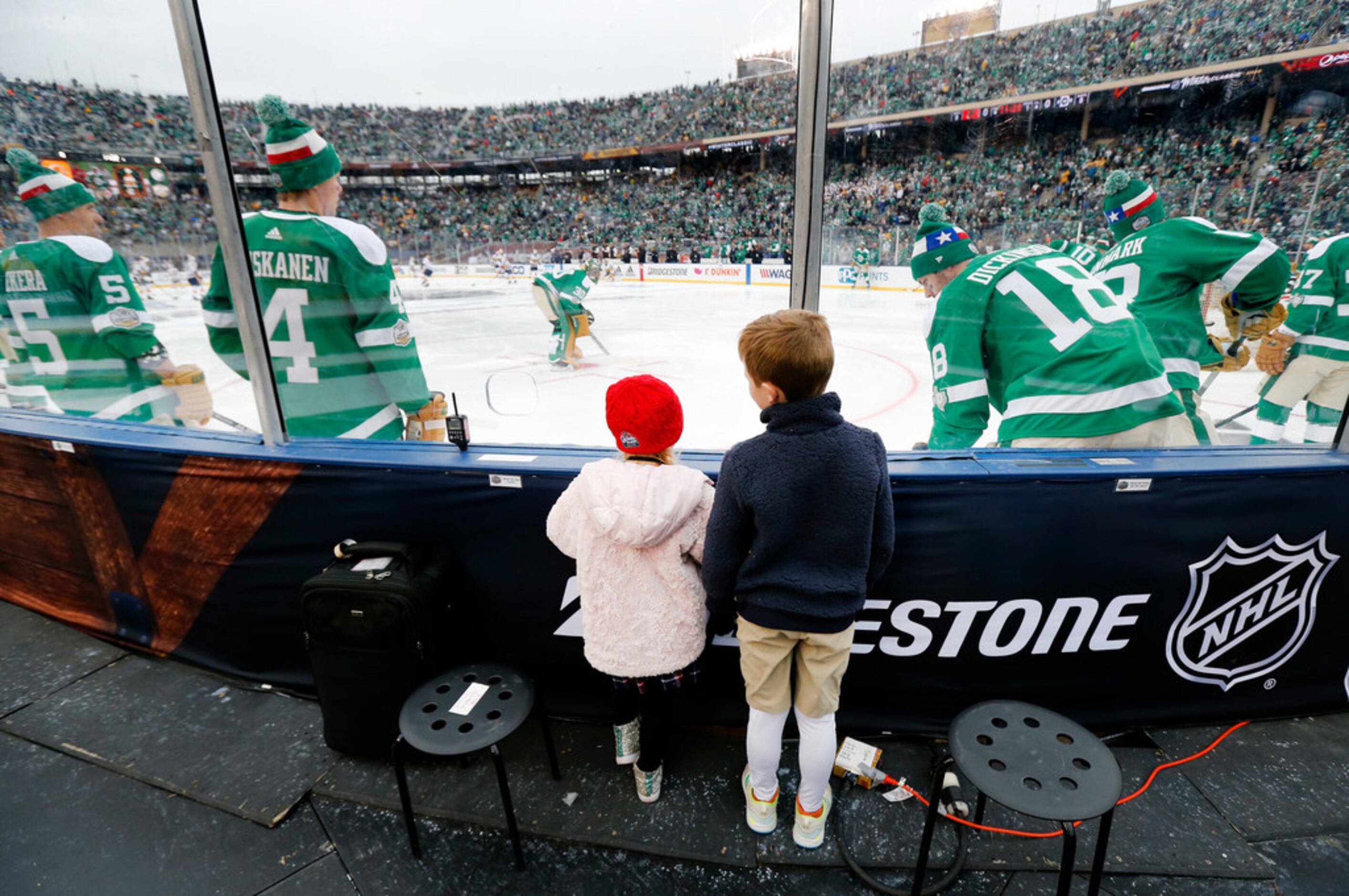 Graeme and Ryanne Egan of Dallas watch the Dallas Stars warm up on the ice before their...