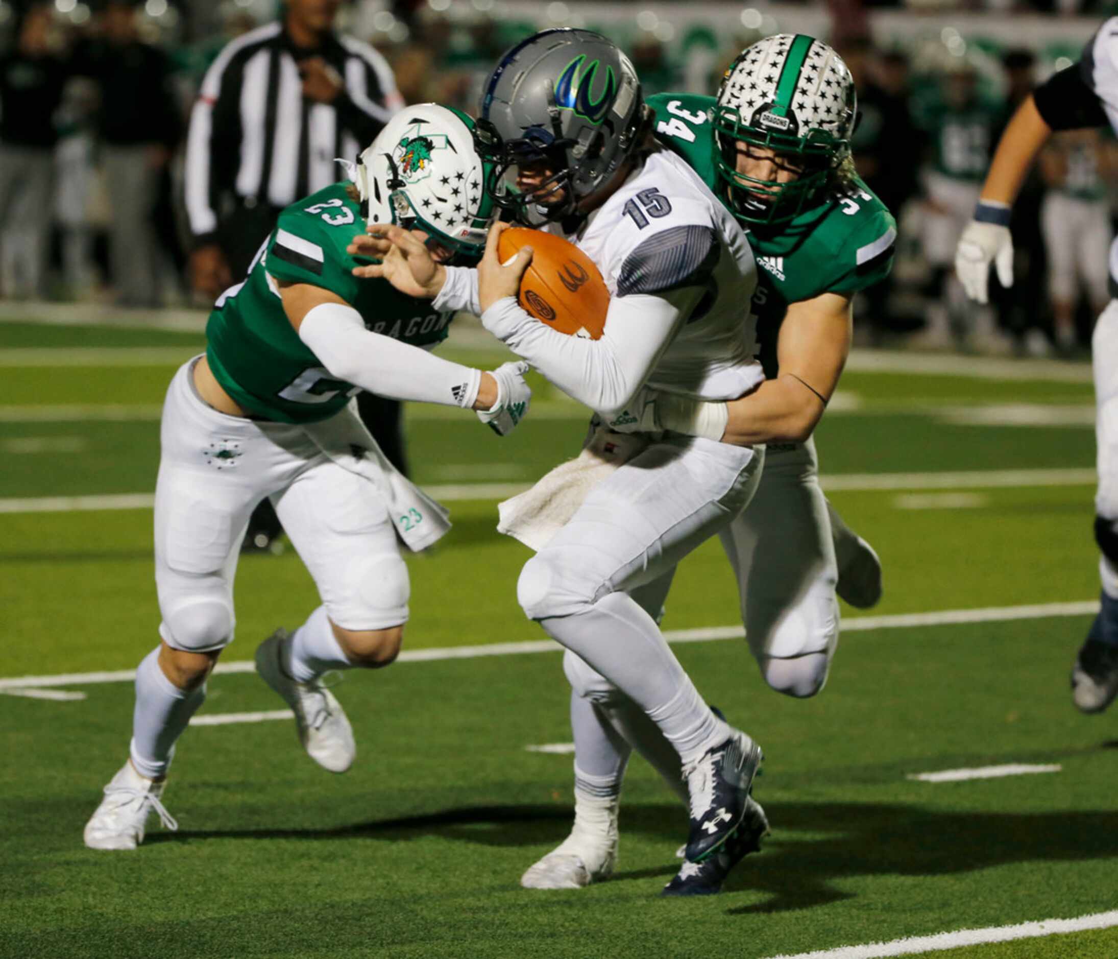 Southlake Carroll's Beck Para (23) and Graham Faloona (34) tackle Eaton's Braden St. Ama...