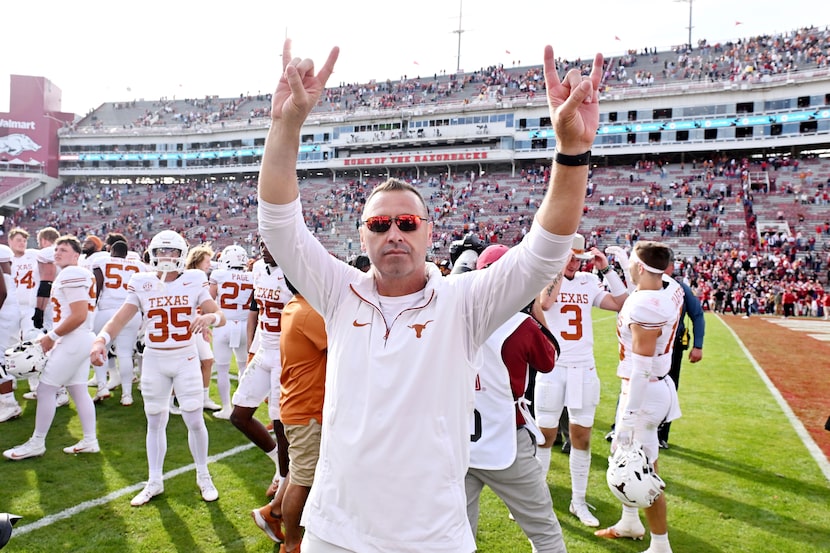 Texas coach Steve Sarkisian celebrates with his team after defeating Arkansas 20-10 in an...