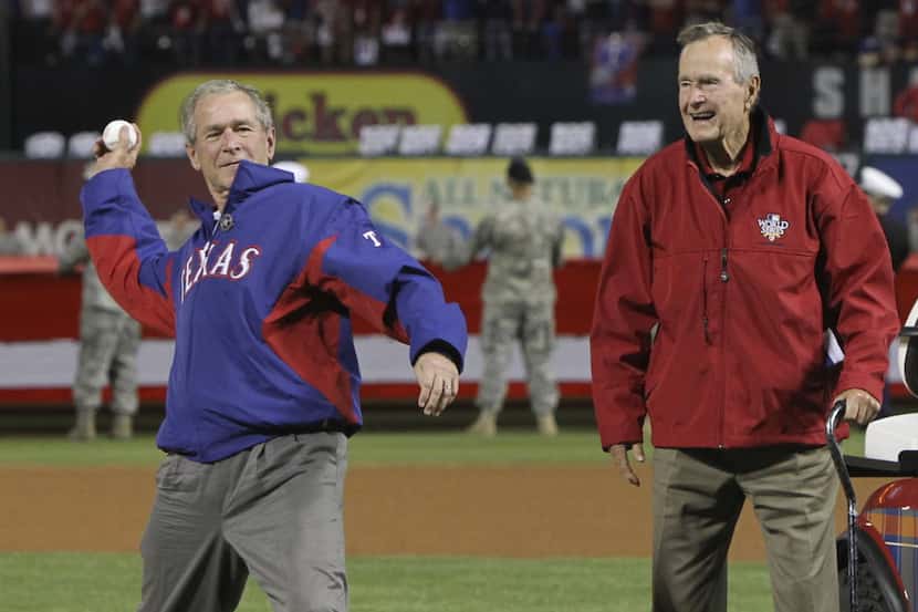 George H.W. Bush accompanied his son George W. Bush to the mound for the ceremonial first...