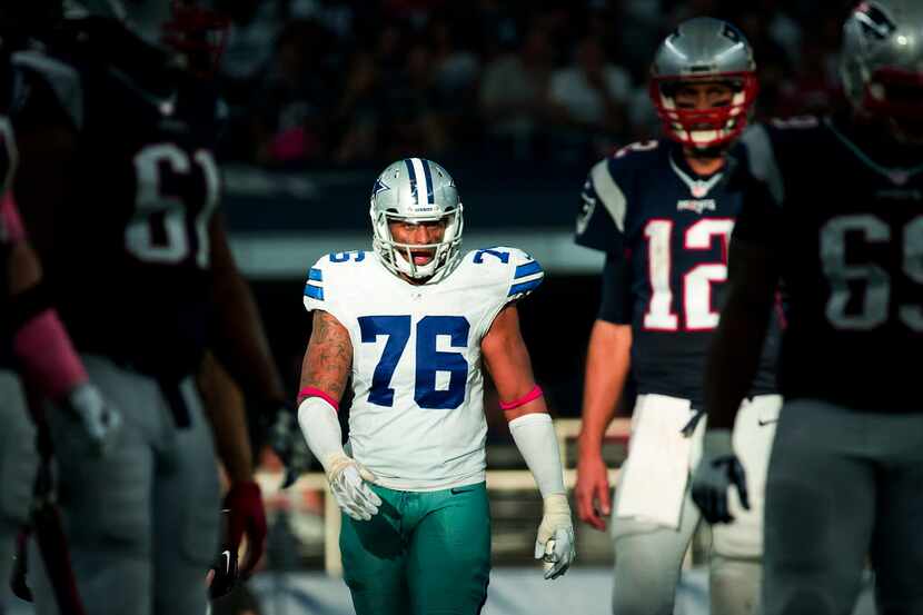 Dallas Cowboys defensive end Greg Hardy (76) eyes New England Patriots quarterback Tom Brady...