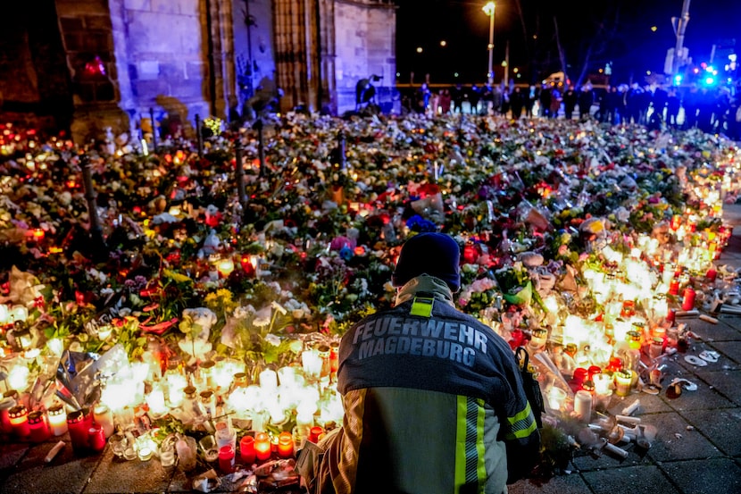 Flowers are laid in front of the Johannis church near the Christmas Market in Magdeburg,...