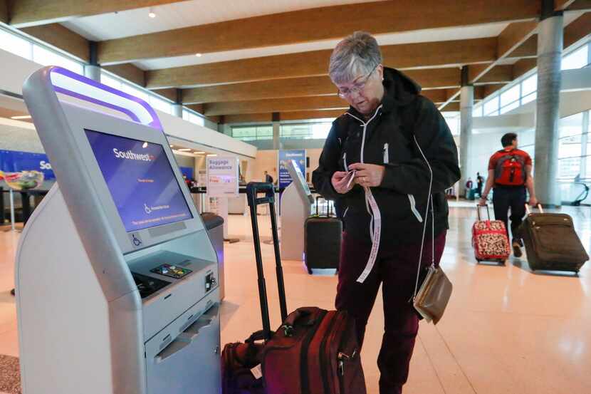 Ann Allen uses a Southwest Airlines kiosk to print some luggage tags at Dallas Love Field...
