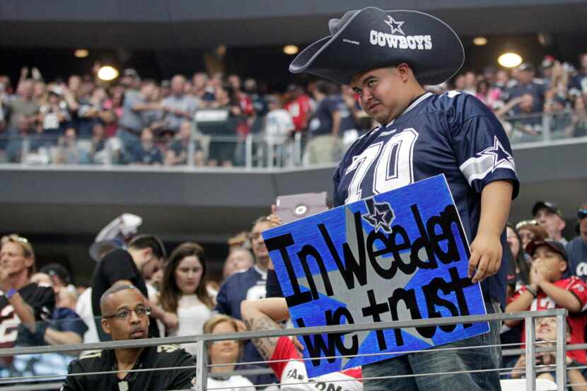 Dallas Cowboys fan in the stands with a Dallas Cowboys quarterback Brandon Weeden (3) sign...