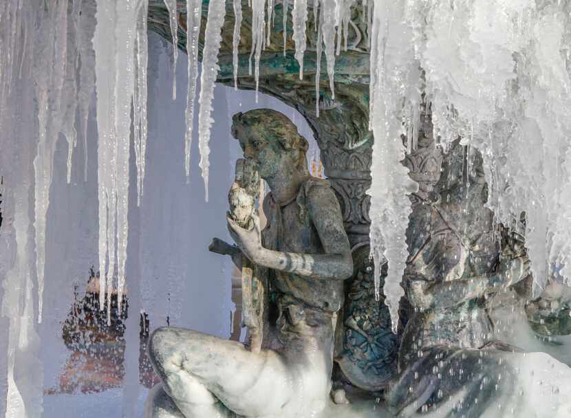 Icicles hang from a fountain at the The Village at Sports Center shopping center in...