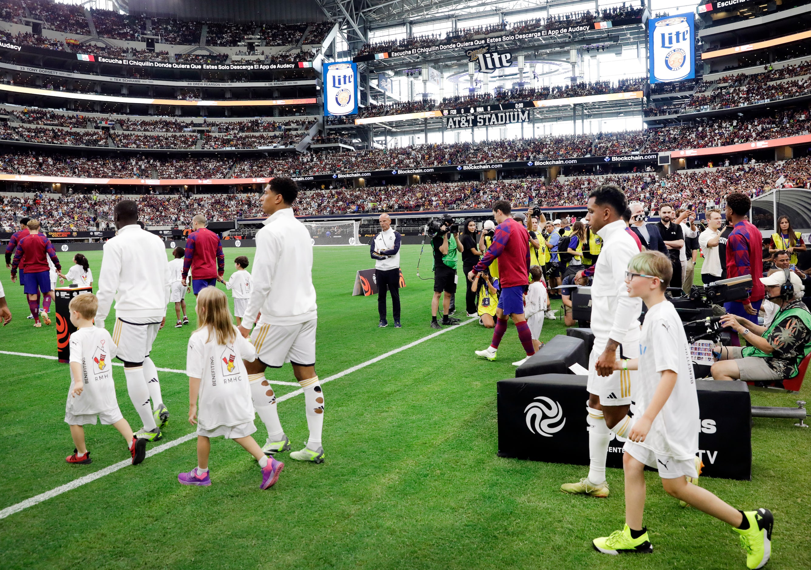 Real Madrid and Barcelona players walk onto the pitch before their Soccer Champions Tour...