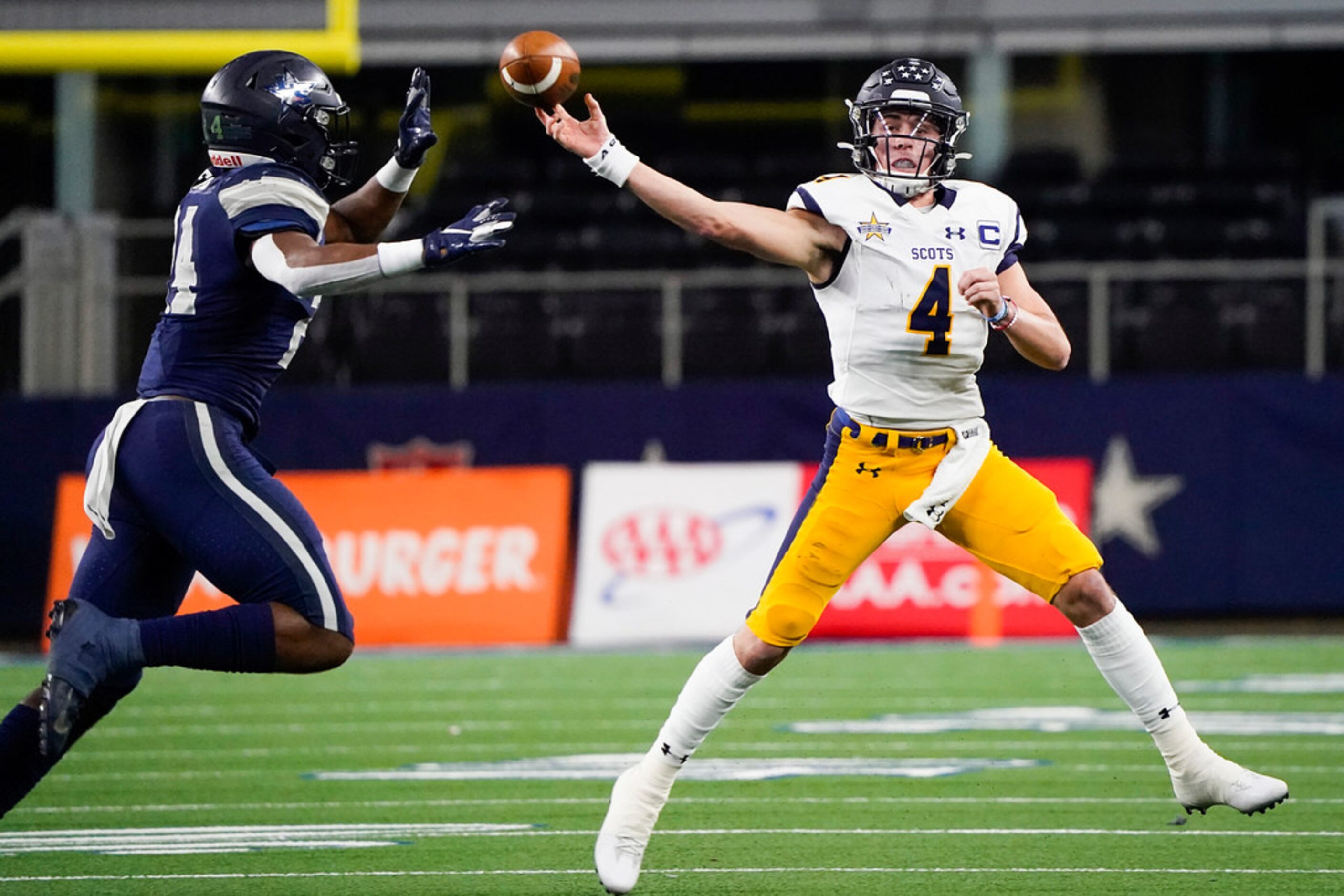 Highland Park quarterback Chandler Morris throws a pass under pressure from Frisco Lone Star...