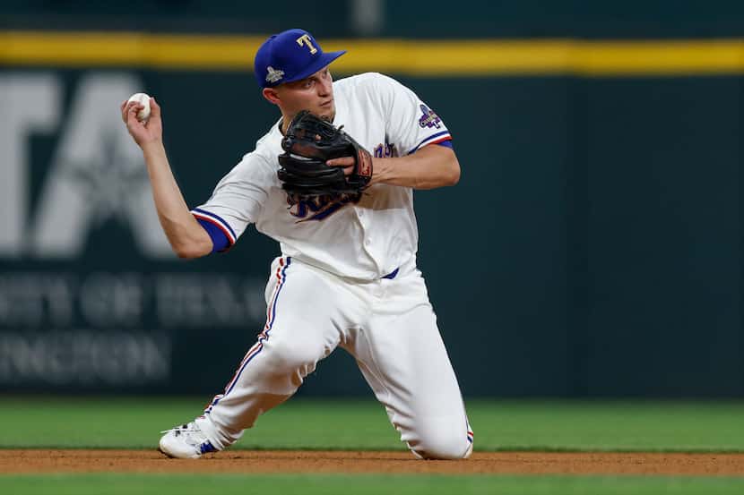 Texas Rangers shortstop Corey Seager (5) throws to second to turn a double play during the...