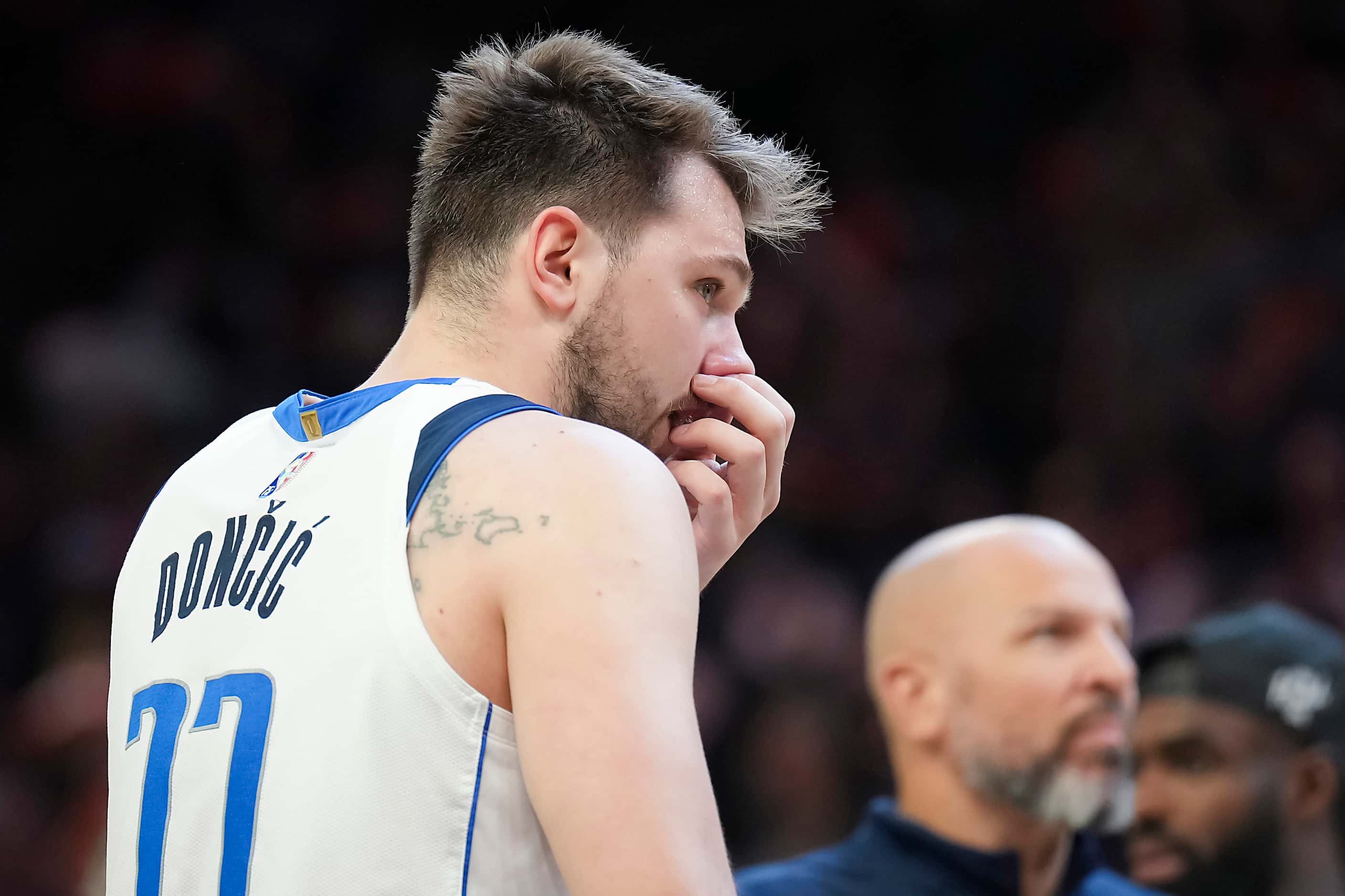 Dallas Mavericks guard Luka Doncic (77) grabs his nose after being fouled during the third...