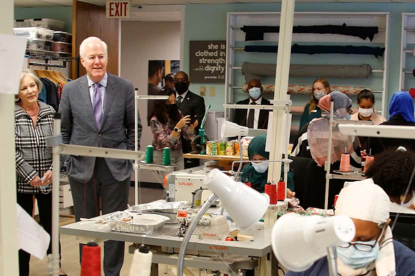 U.S. Sen. John Cornyn and wife Sandy observe as Afghan women sew articles in the nonprofit...