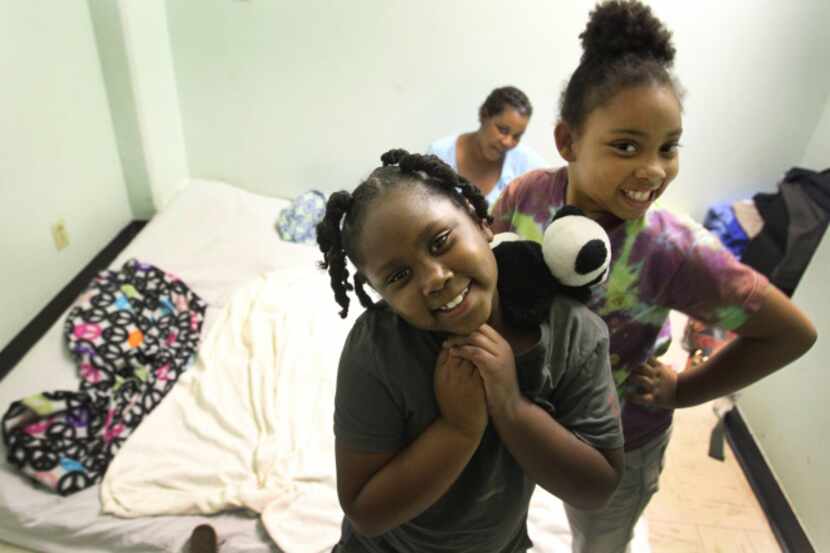 Topaz Griggs watches as daughters Arianna Scott, 6, (left) and Jakayla Asbell, 8, play in...